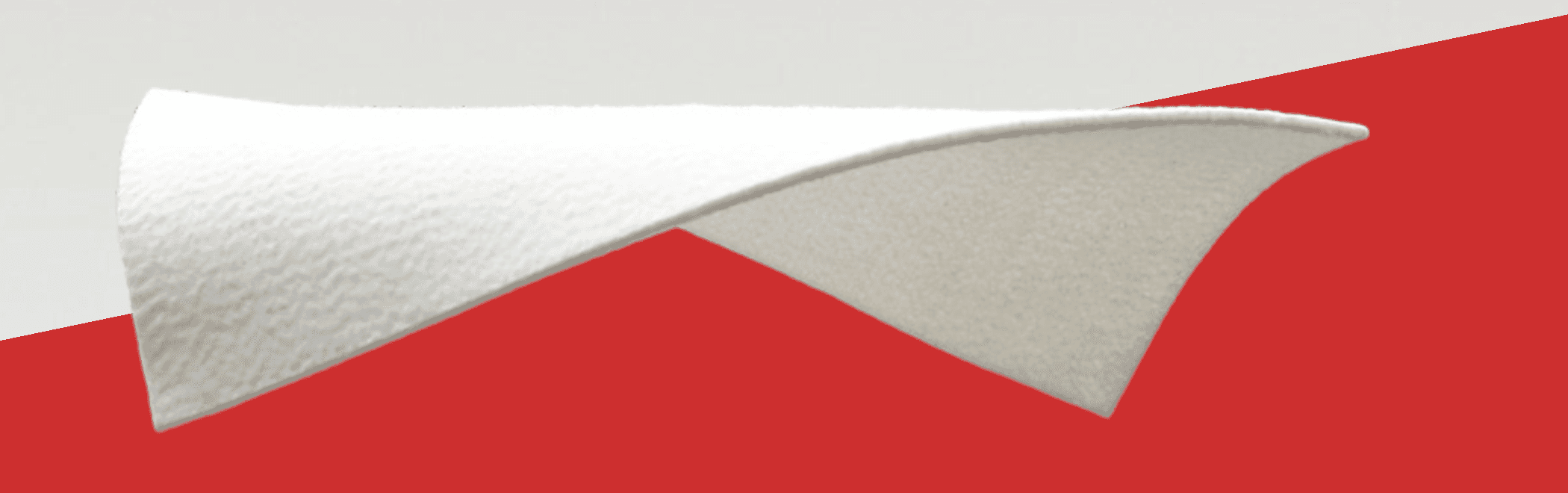 White VACUTEX™ wound dressing photographed over the brand's diagonal red and gray field